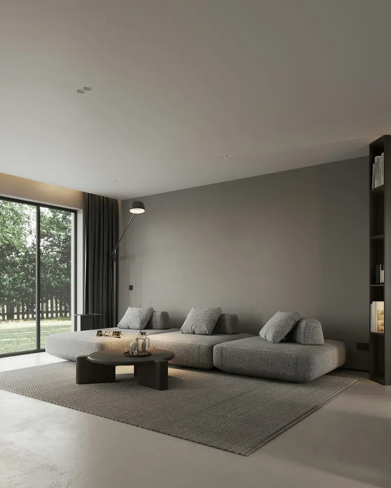 A quiet, minimal grey room with a big window onto the garden